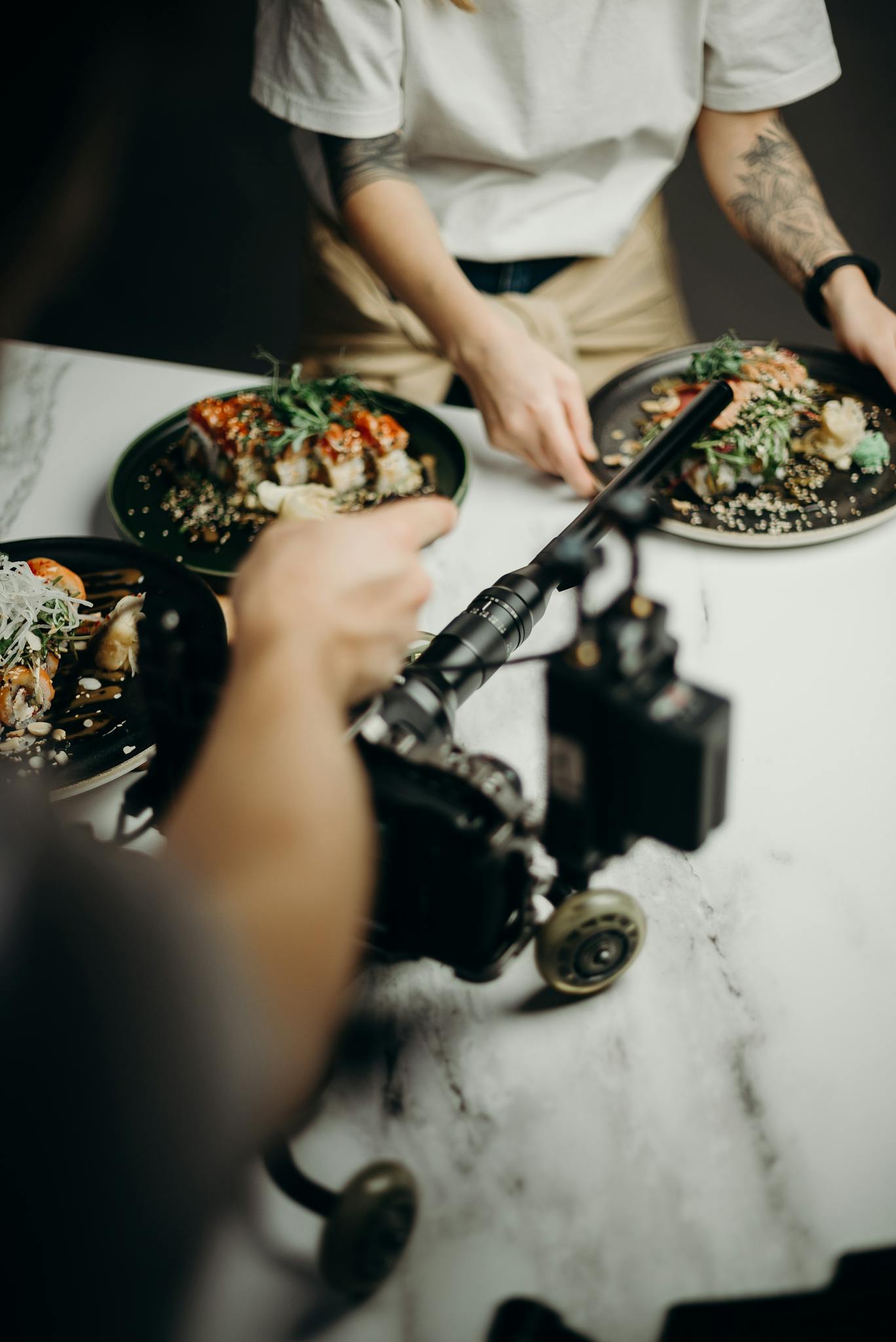 A behind-the-scenes look at a food photoshoot with Japanese dishes being styled and filmed.